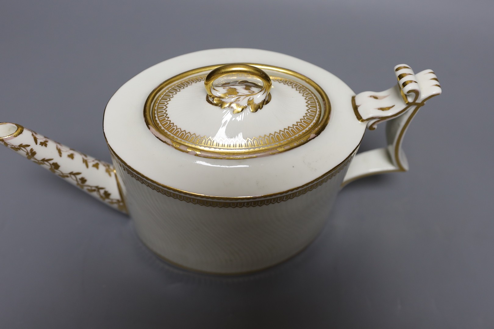 A Derby puce mark teapot and cover, late 18th century, with wavy parallel moulding with ornate gilded decoration, pattern to base. 26cm